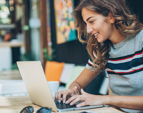 Smiling woman using a laptop